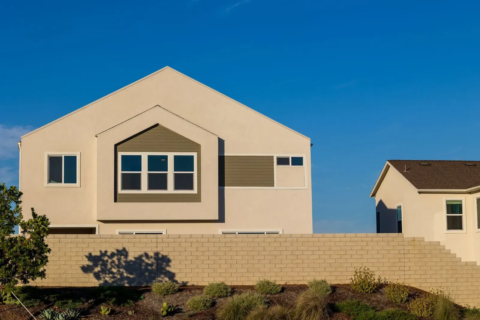 Stucco home against a clear blue sky