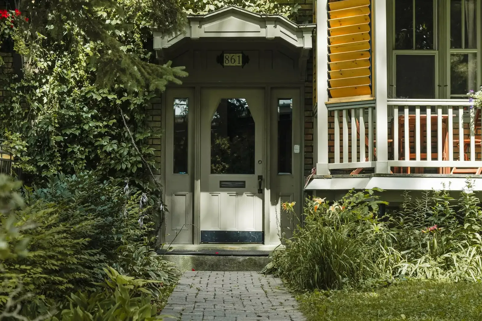 Front walkway and entrance of a home surrounded by greenery